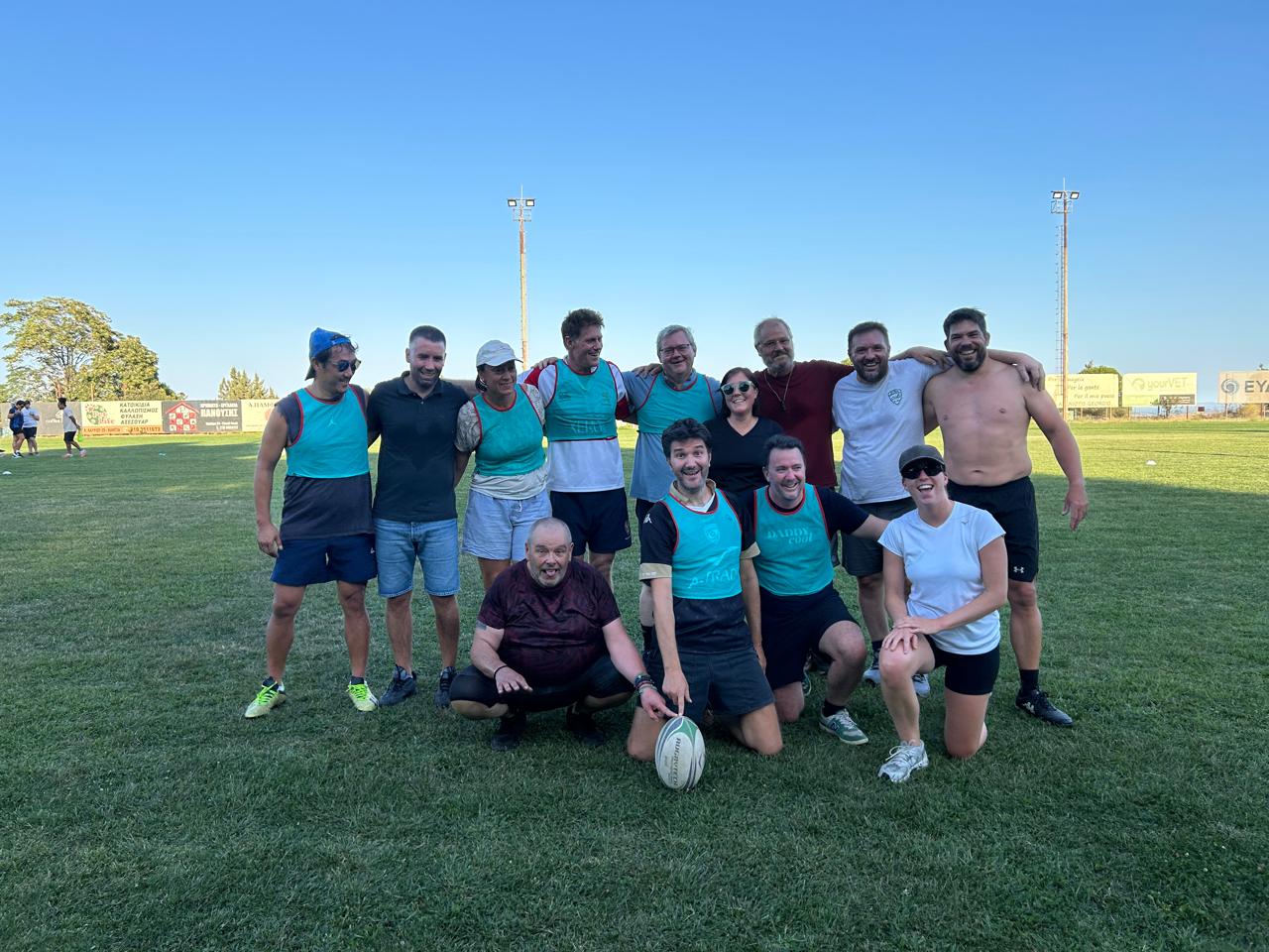 Attica Rugby Rubies & Rugby 5 squad smiling on the pitch