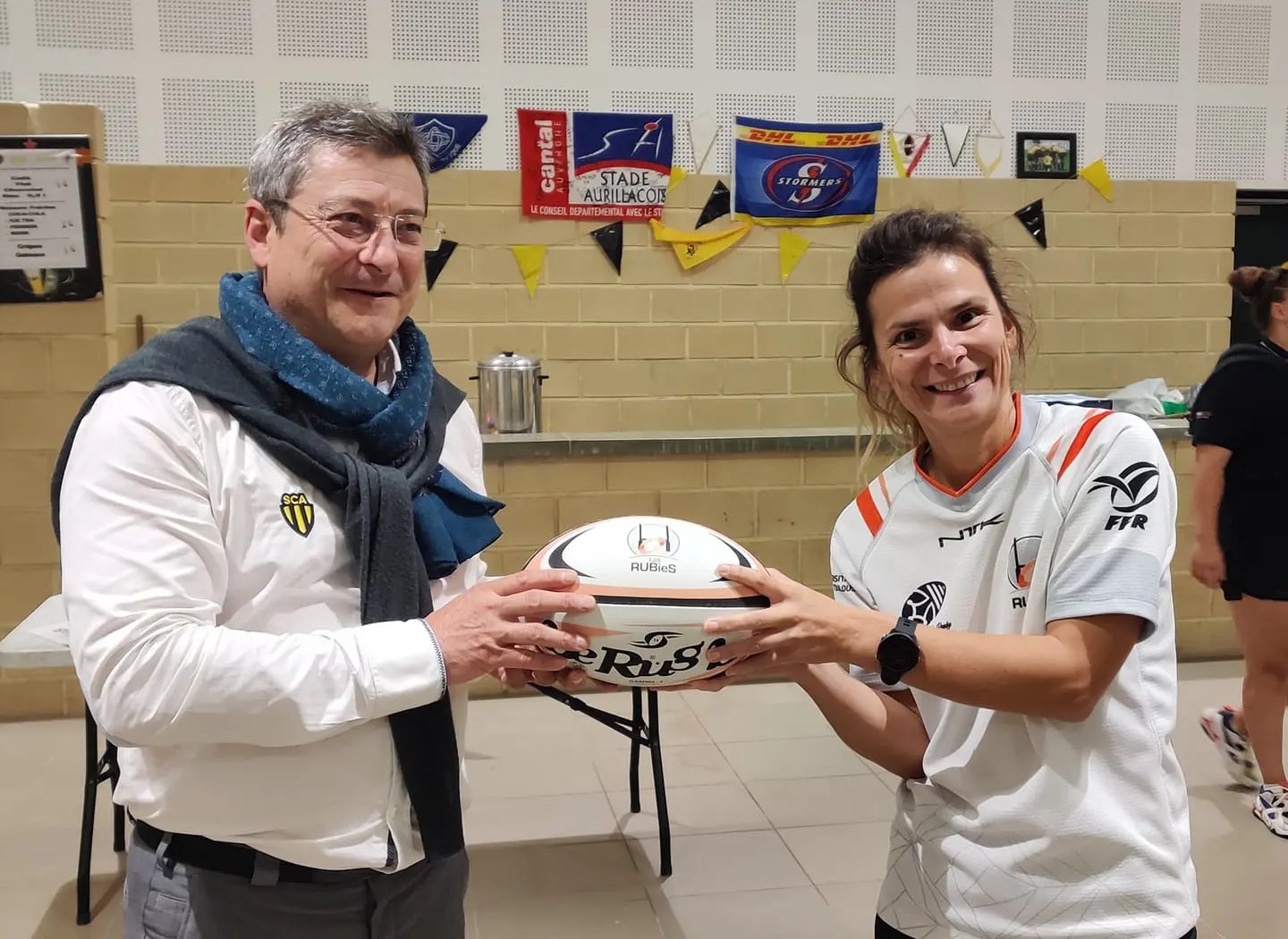 Dr. Stéphanie Motton presenting the official Les RUBieS rugby ball